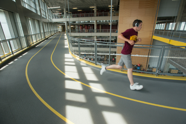 student running on the track at the Minneapolis rec center