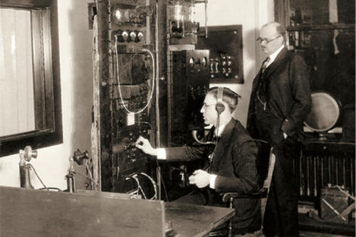 Student working an early electronic switchboard